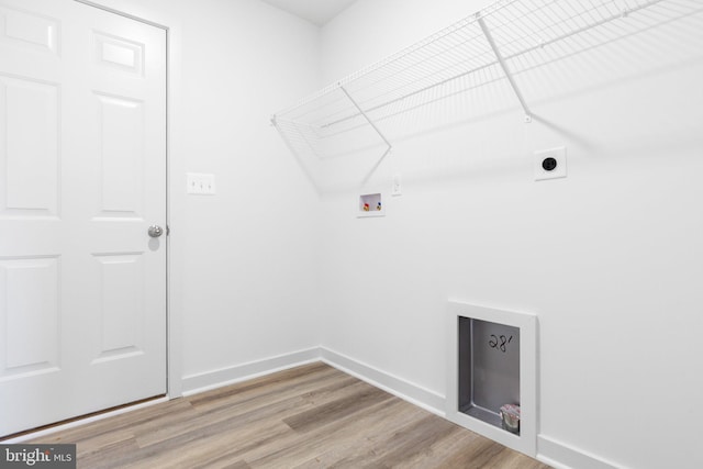 laundry room with hookup for a washing machine, hookup for an electric dryer, and light hardwood / wood-style flooring