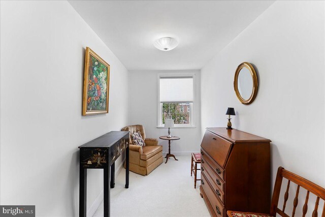 sitting room featuring light colored carpet