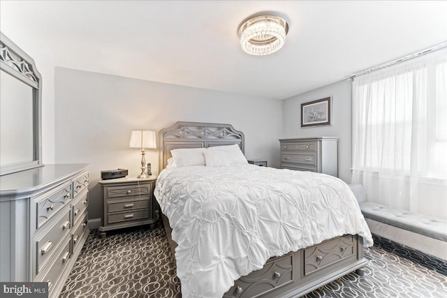 carpeted bedroom with a chandelier