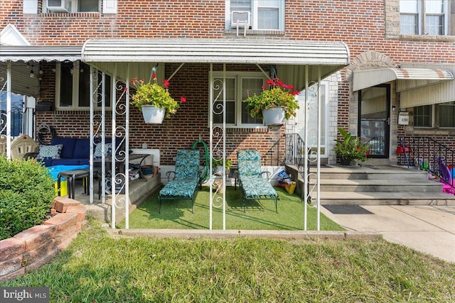 doorway to property with brick siding and outdoor lounge area