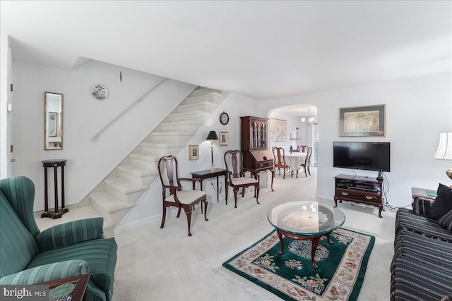 carpeted living room featuring wooden walls