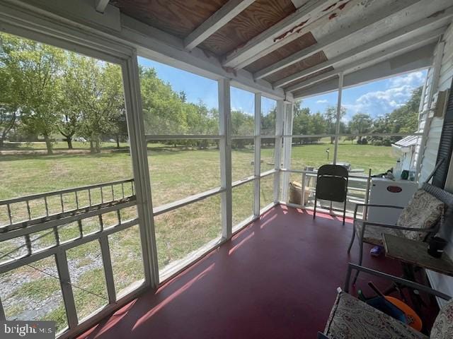 sunroom featuring beamed ceiling