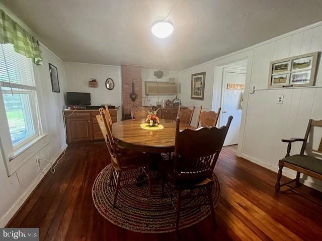 dining area featuring dark wood-style floors and baseboards