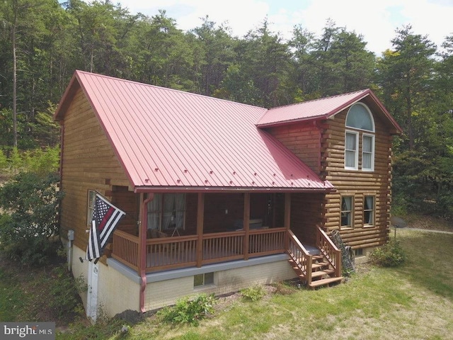 back of house featuring a porch