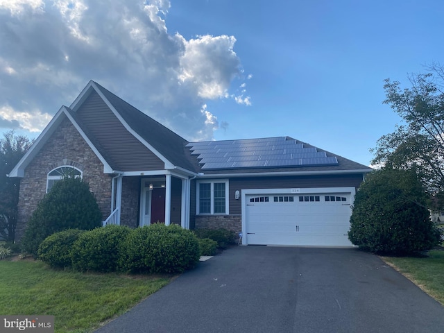 view of front of house featuring a garage and solar panels