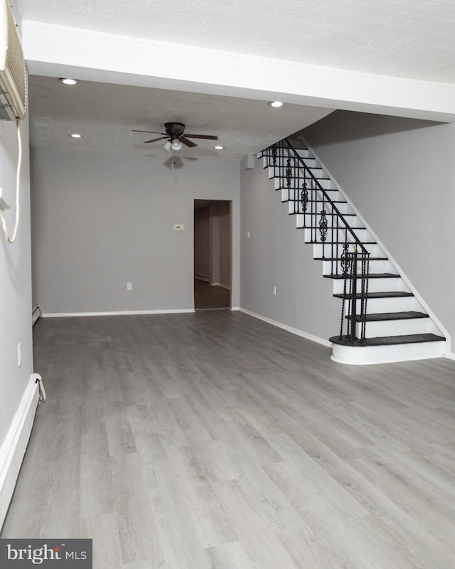 unfurnished living room featuring hardwood / wood-style floors and ceiling fan