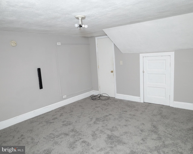 bonus room with a textured ceiling and carpet