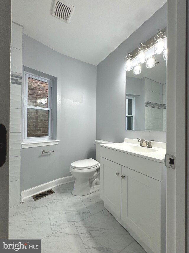 bathroom featuring visible vents, marble finish floor, toilet, and baseboards