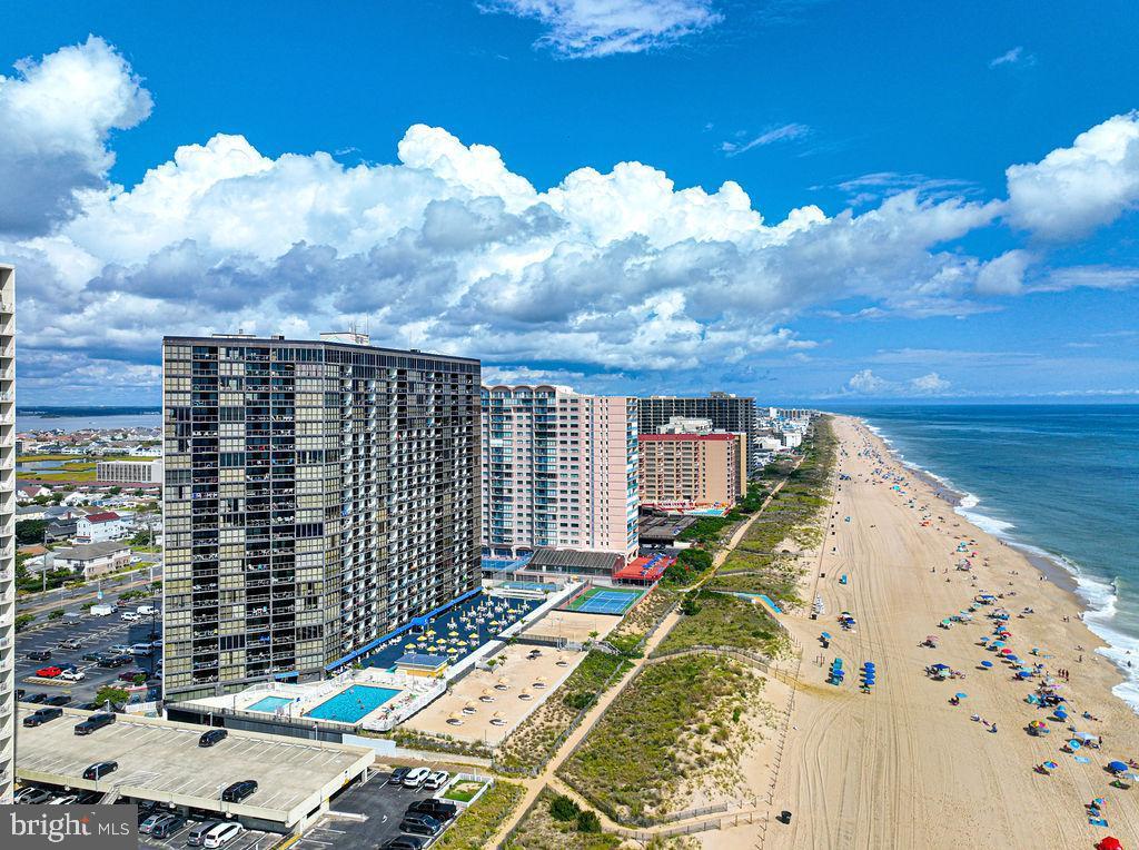 drone / aerial view featuring a water view and a view of the beach