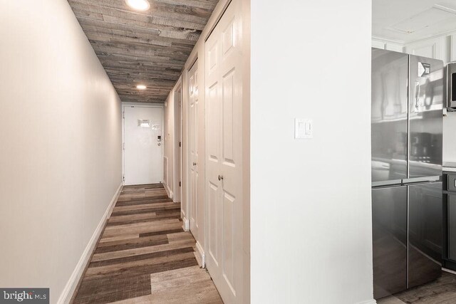 corridor with wood ceiling and wood-type flooring