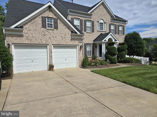 view of front of property with a garage and a front lawn