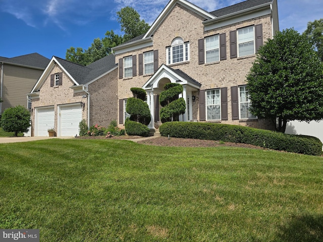 view of front of property featuring a garage and a front lawn