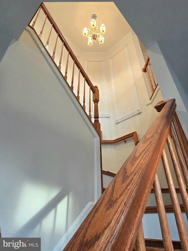 stairs featuring a notable chandelier