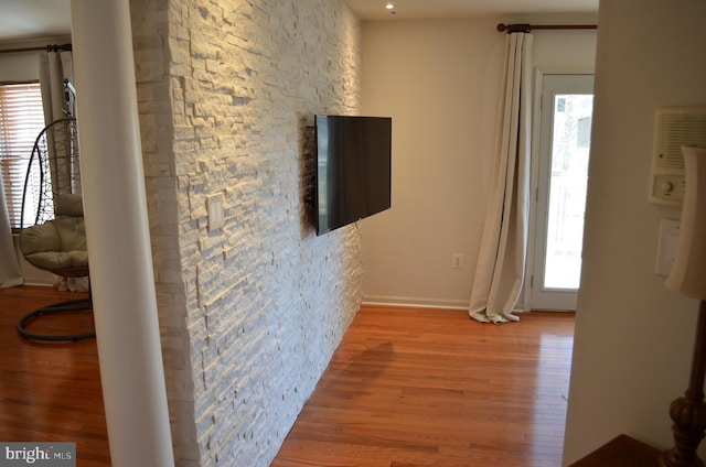 corridor with light hardwood / wood-style floors