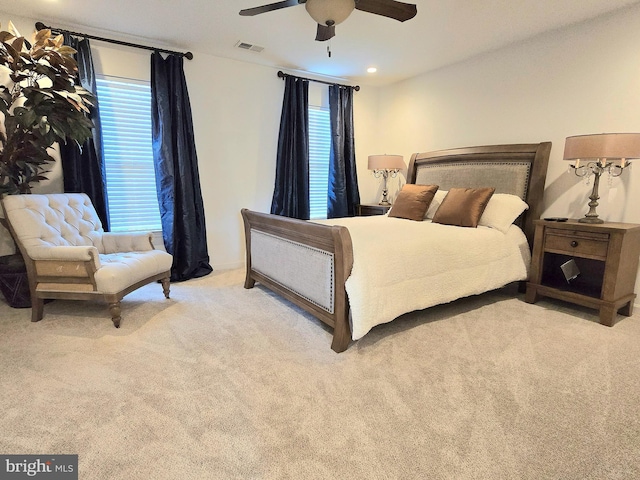 bedroom featuring light colored carpet and ceiling fan