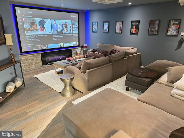 cinema room with wood finished floors and recessed lighting