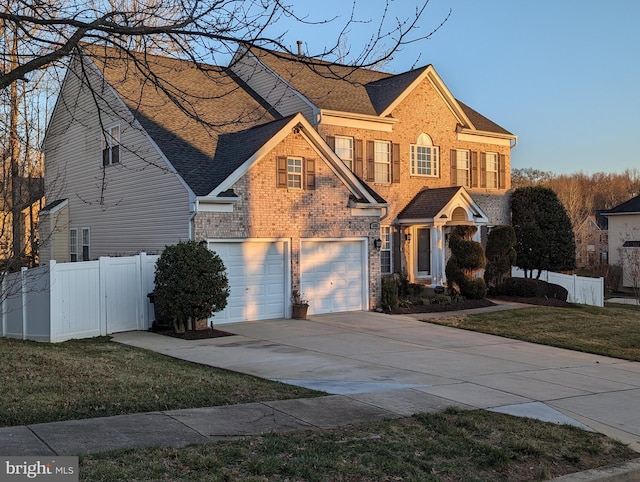 view of front of property with a garage and a front yard