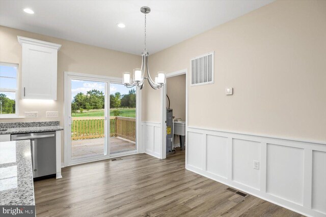 kitchen featuring light wood-type flooring, white cabinets, light stone counters, sink, and stainless steel appliances