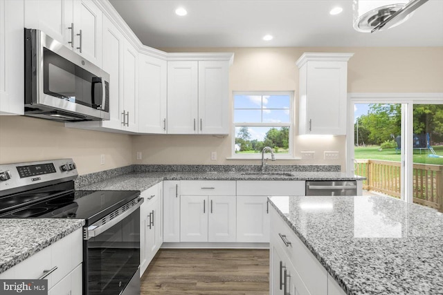 kitchen featuring light hardwood / wood-style floors, sink, stainless steel appliances, and white cabinets