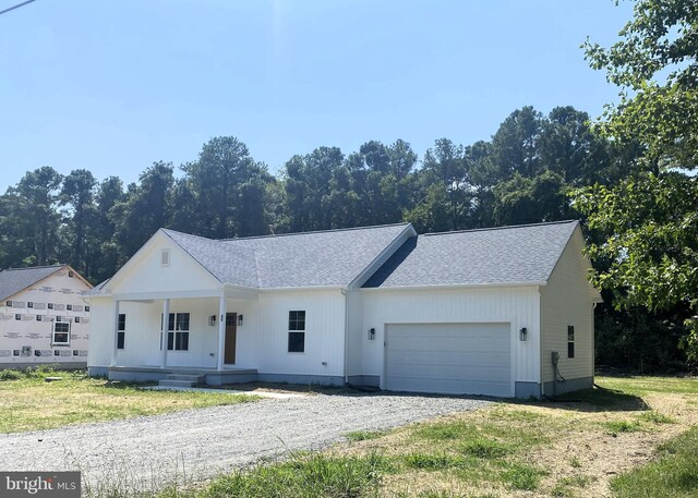 view of front of property featuring covered porch and a garage