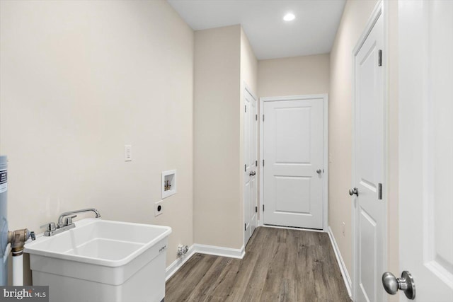 laundry room with hookup for an electric dryer, laundry area, washer hookup, wood finished floors, and a sink