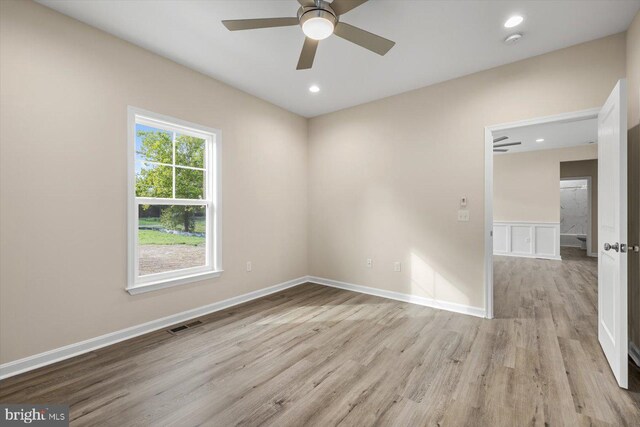 bathroom with toilet, hardwood / wood-style floors, double sink vanity, and a tile shower