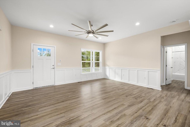 empty room with light wood-type flooring and ceiling fan