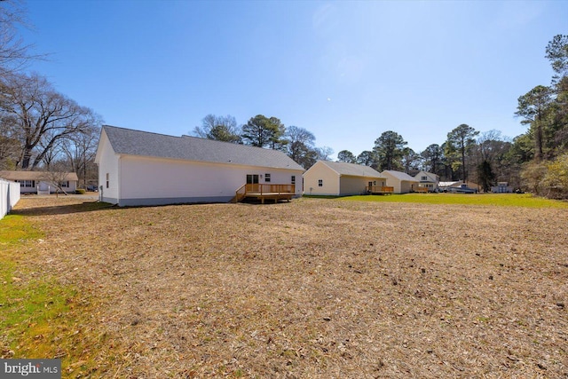 exterior space featuring a yard and a wooden deck