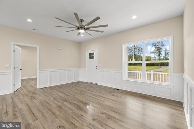 empty room with light hardwood / wood-style flooring and ceiling fan