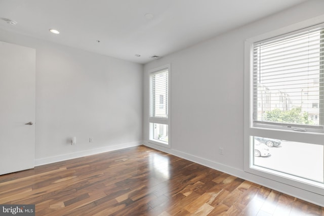 spare room featuring dark wood-type flooring