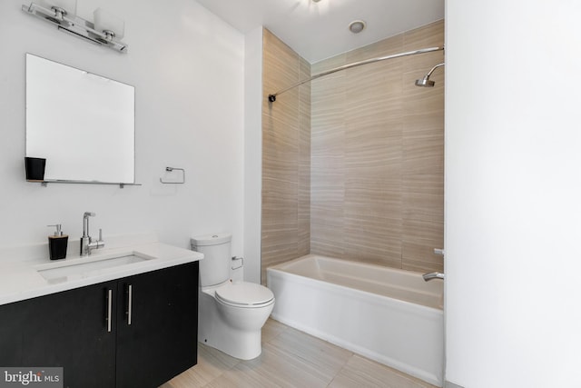 full bathroom featuring toilet, tiled shower / bath, and vanity