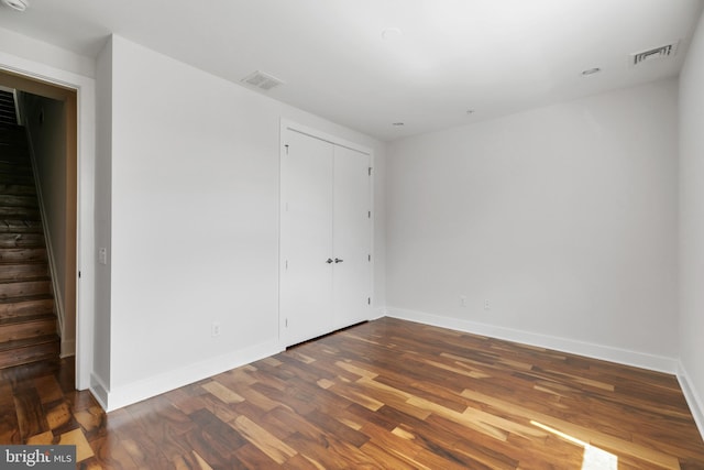 unfurnished bedroom with dark hardwood / wood-style floors