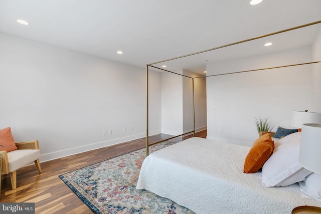 bedroom with a closet and hardwood / wood-style flooring