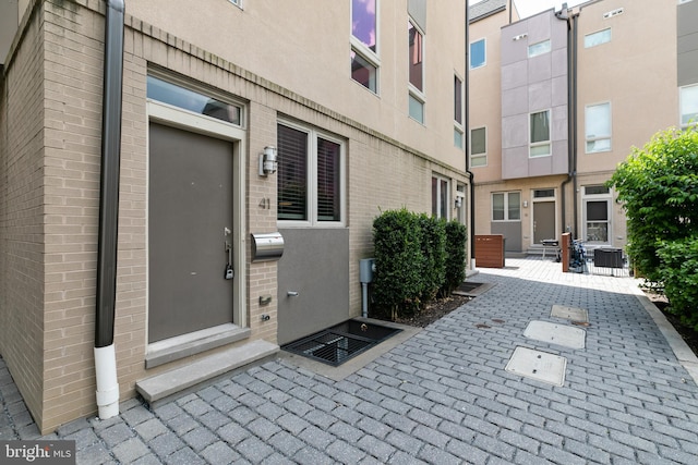 exterior entry at dusk featuring a patio area