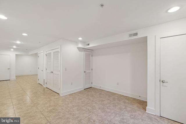 basement with light tile patterned flooring