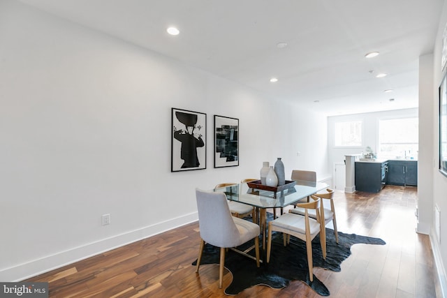 dining space with dark wood-type flooring