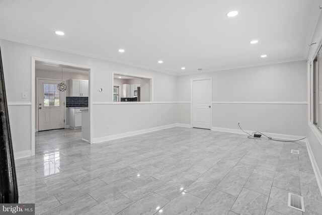 unfurnished living room with light tile patterned floors and crown molding