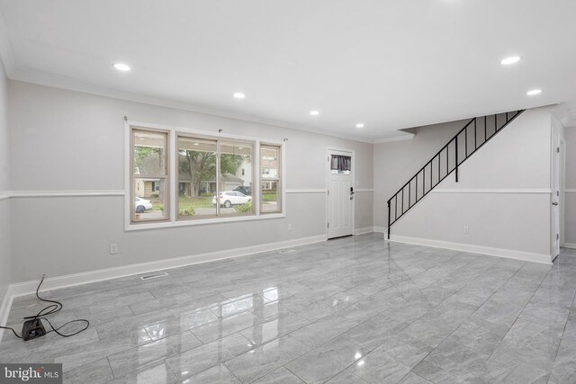 unfurnished room featuring light tile patterned flooring and ornamental molding