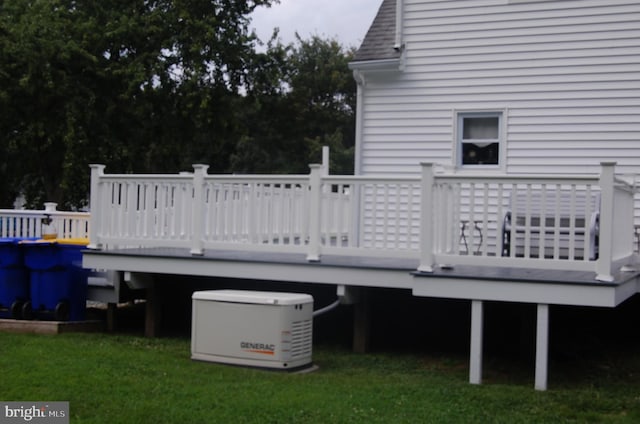 wooden deck featuring a yard