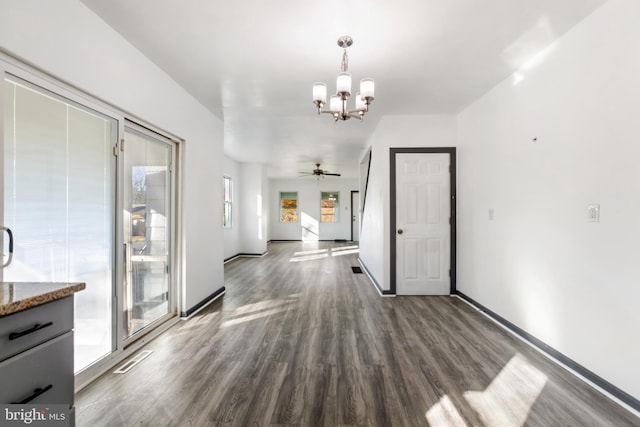 interior space with dark wood-type flooring, a chandelier, and a healthy amount of sunlight