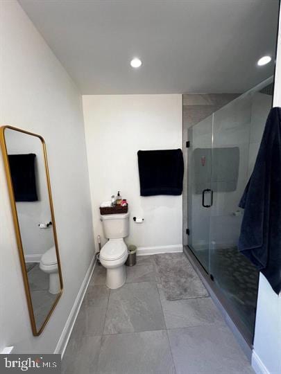 bathroom featuring tile patterned floors, walk in shower, and toilet