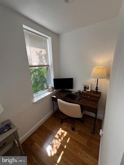 home office with hardwood / wood-style floors