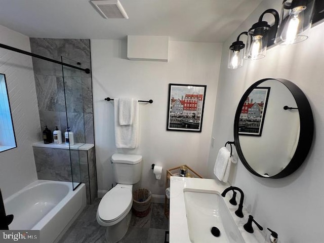 bathroom with toilet, tiled shower / bath combo, and tile patterned floors