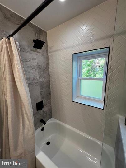 bathroom featuring shower / bath combination with curtain