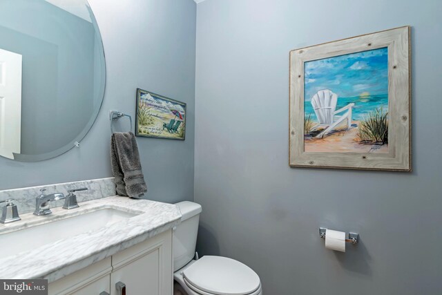 bathroom with toilet and vanity