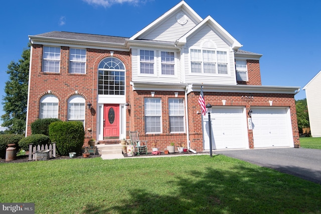 view of front of house with a front yard and a garage