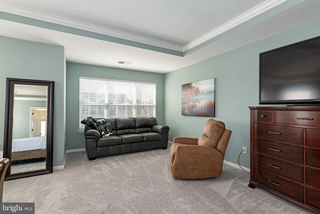 living room with light carpet, crown molding, and a tray ceiling