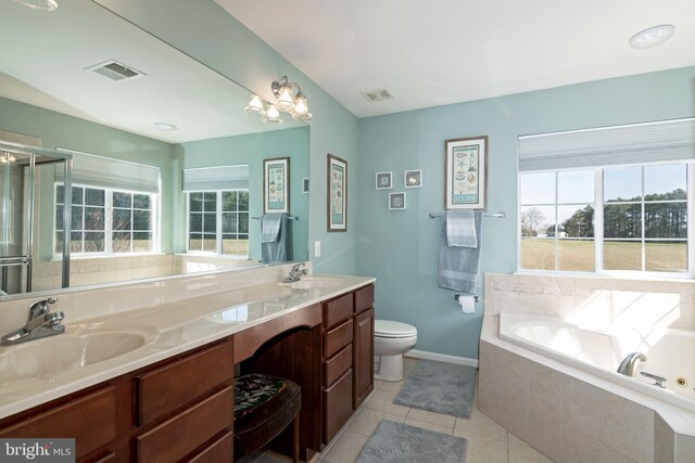 bathroom with a relaxing tiled tub, toilet, tile patterned floors, and vanity