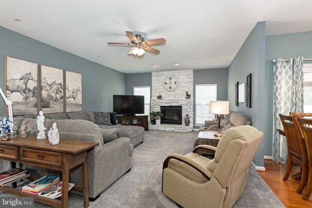 living room with ceiling fan, hardwood / wood-style floors, and a fireplace