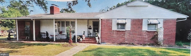 bungalow-style house with a porch, a chimney, a front lawn, and brick siding